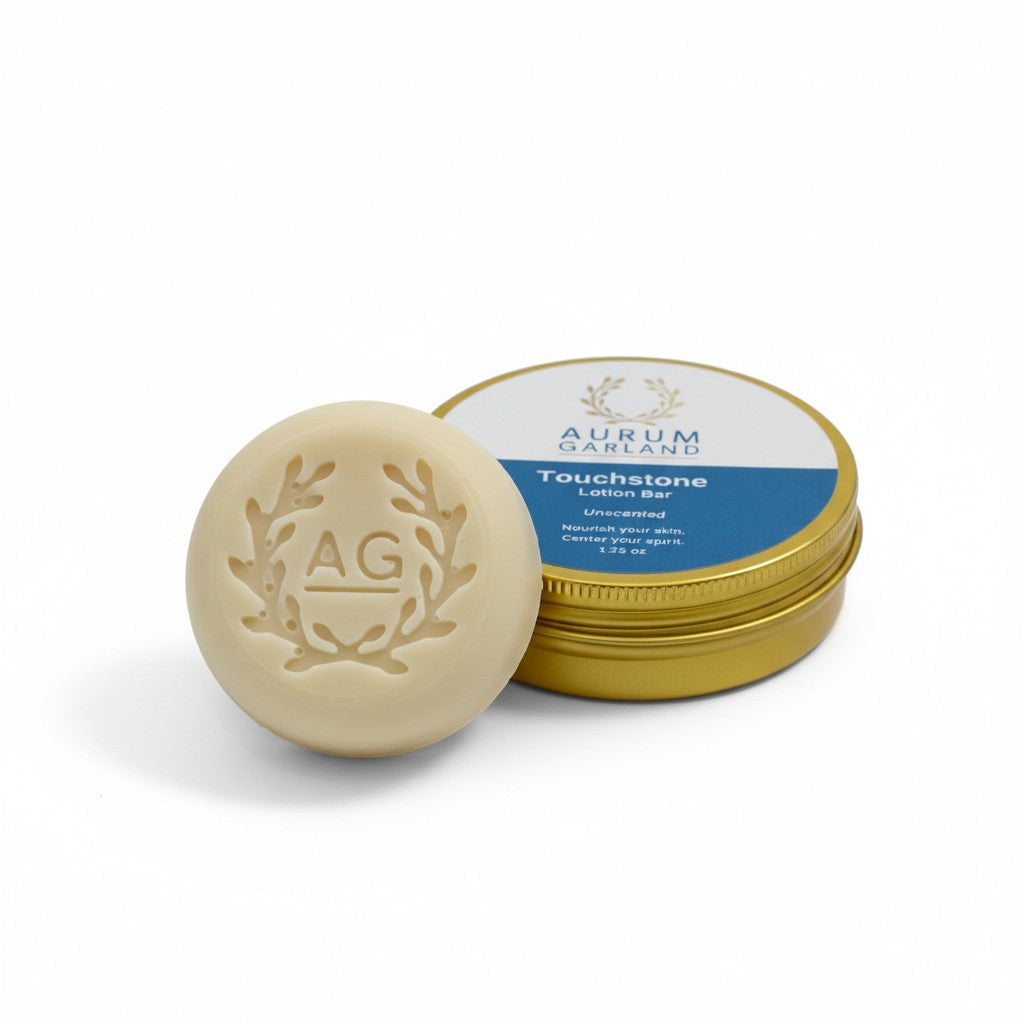 Beige lotion bar with gold lid featuring 'AG' logo on a white background